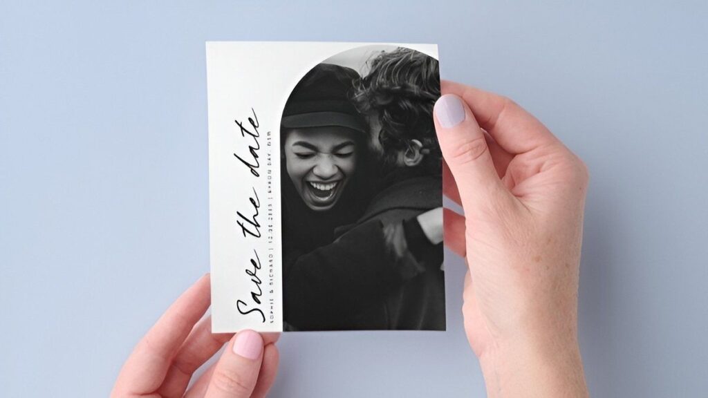 Affordable black and white photo save the date card with modern typography and engagement portrait
